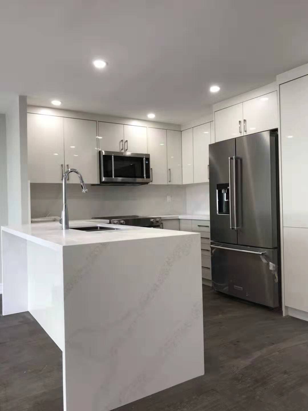 Contemporary Kitchen Featuring White High Gloss Cabinets