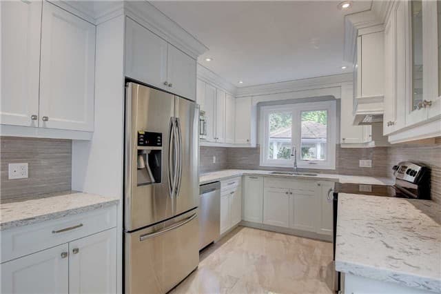 Transitional Kitchen Featuring U Shape Design and Custom Made Hood